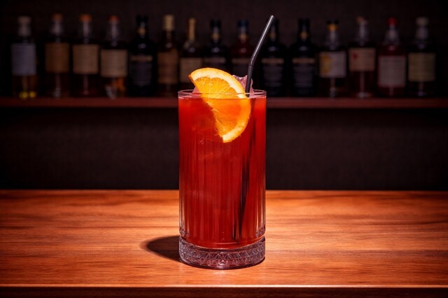Mix of vodka, peach liqueur, cranberry and orange juice with grenadine and orange.