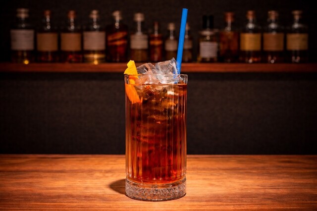 Mix of Campari, red vermouth and soda with orange zest.
