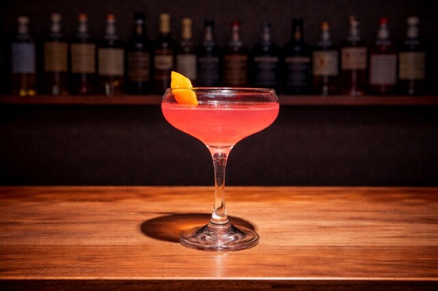 Mix of vodka, triple sec, cranberry juice and lime juice with orange zest.